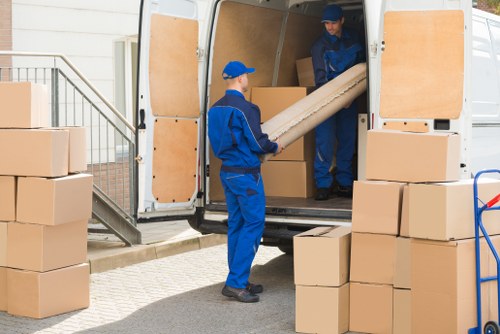 Removals team supporting a Surrey home move with boxes and furniture