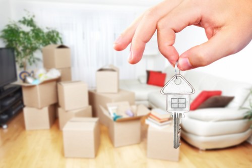 Team member handling moving boxes safely during a van service