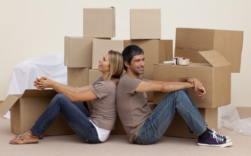 Professional moving team handling furniture and boxes for a Surrey property