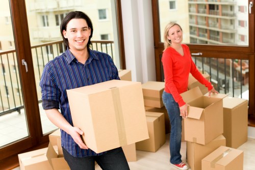 Packed office equipment and furniture ready for a Surrey business move